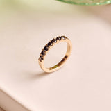 Handmade 9ct yellow gold wedding ring set with seven 2.5mm natural black diamonds; a modern, minimalist design perfect for unique wedding bands or alternative fine jewellery.