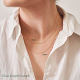 Two necklace chains being worn to show the difference in lengths between a 45cm chain and a 50cm chain.