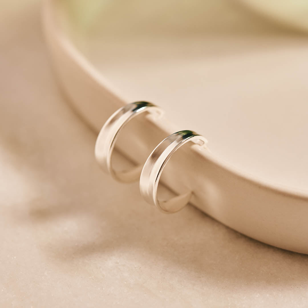 Sterling silver hoop earrings inspired by the shapes created by folding leaves