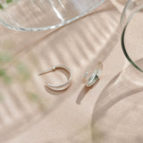 Sterling silver hoop earrings inspired by the shapes created by folding leaves