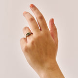 Unique handmade cluster engagement ring in 9ct yellow gold, featuring an oval green sapphire centre stone surrounded by a colourful bouquet-inspired mix of yellow, green, and blue sapphires with two natural diamonds.