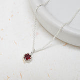 Bright pink tourmaline gemstone set in a silver King Protea pendant on a silver rolo chain.