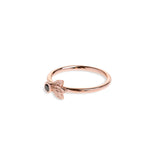 Black diamond in a classic tube setting on a rose gold ring with three leaf details