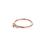 Black diamond in a classic tube setting on a rose gold ring with two leaf details