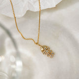 Forget-Me-Not flower inspired pendant with leaf detail, manufactured in 9ct yellow gold, set with light blue sapphires, and on a 9ct yellow gold rolo chain