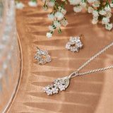 Forget-Me-Not flower inspired pendant with leaf detail, manufactured in sterling silver, set with lilac sapphires, and on a sterling silver rolo chain. Photographed with the Sapphire Forget-Me-Not studs