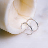 Botanica's sterling silver Branch Hoops captured simply on a marble table