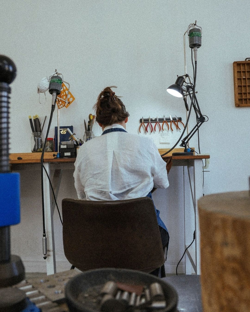 Claire Hand Manufacturing Jewellery at the bench in a jewellery studio and workshop 