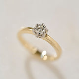 A close up photograph of the two tone Botanica Protea Ring showing the detail of the four claw setting holding the natural diamond and the solid platinum protea petals. 