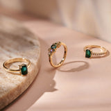 Three Botanica Bespoke gemstone rings photographed together.