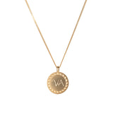 Yellow gold disc pendant with wreath border and engraved initials.