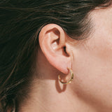 9ct yellow gold hoop earrings inspired by the shapes created by folding leaves and with engraved detailing