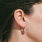Sterling silver hoop earrings inspired by the shapes created by folding leaves