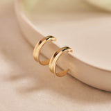 9ct yellow gold hoop earrings inspired by the shapes created by folding leaves
