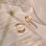 9ct yellow gold hoop earrings inspired by the shapes created by folding leaves