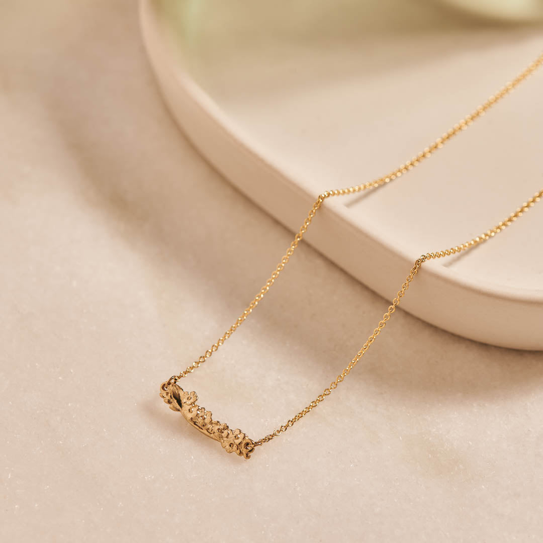 Forget-Me-Not Flower inspired bar pendant manufactured in 9ct yellow gold on a 9ct yellow gold rolo chain