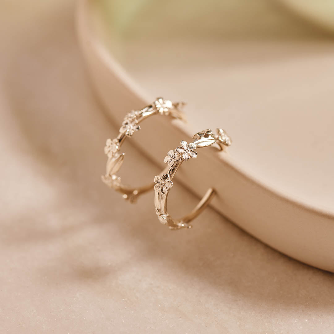Sterling silver hoop earrings with Forget-Me-Not flower and leaf details