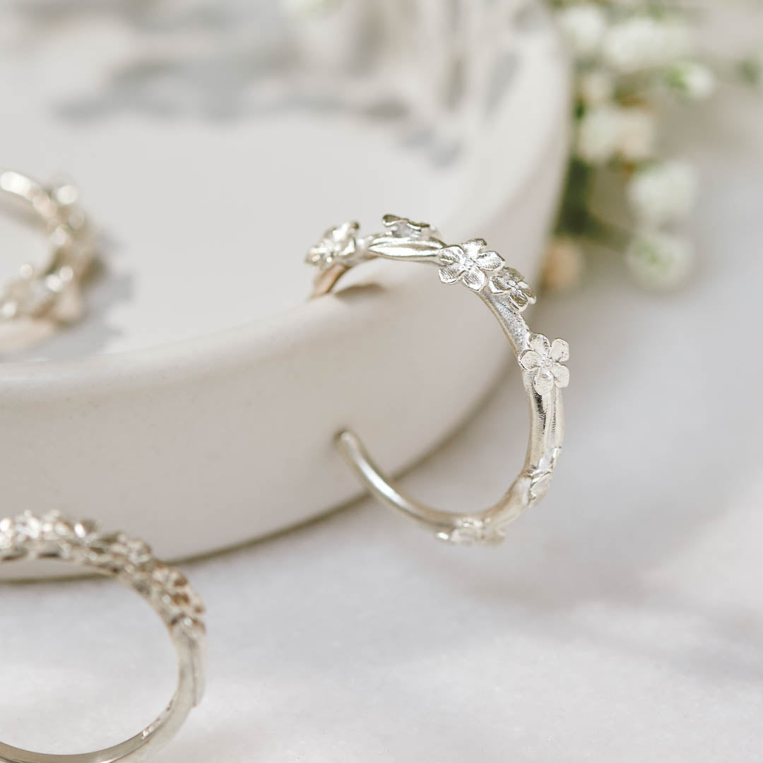 Sterling silver hoop earrings with Forget-Me-Not flower and leaf details