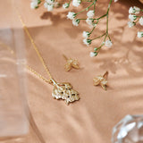 Forget-Me-Not Flower inspired studs with leaf details manufactured in 9ct yellow, photographed with the Forget-Me-Not necklace