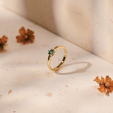 A round light blue tourmaline set in a yellow gold ring