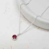 Bright pink tourmaline gemstone set in a silver King Protea pendant on a silver curb chain.