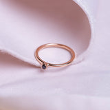 Black diamond in a classic tube setting on a rose gold ring