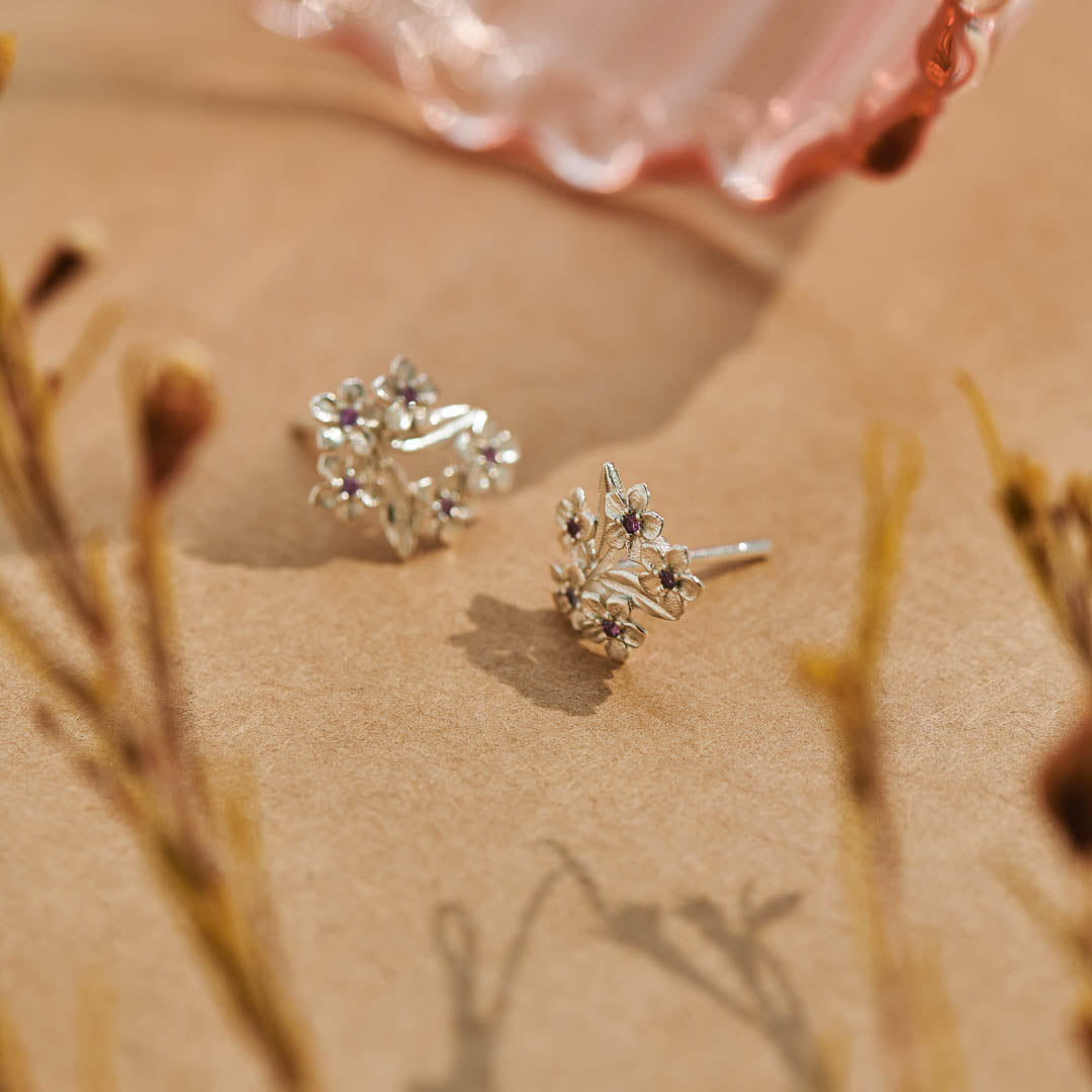 Forget-Me-Not Flower inspired studs with leaf details manufactured in sterling silver and set with lilac sapphires