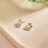 Forget-Me-Not Flower inspired studs with leaf details manufactured in sterling silver and set with lilac sapphires
