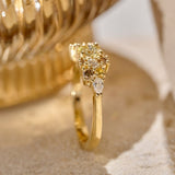 Side view of a solid gold earth-toned Bouquet Ring featuring a central yellow-toned diamond surrounded by smaller colourless and cognac diamonds, yellow sapphires and natural pear shaped diamonds. 