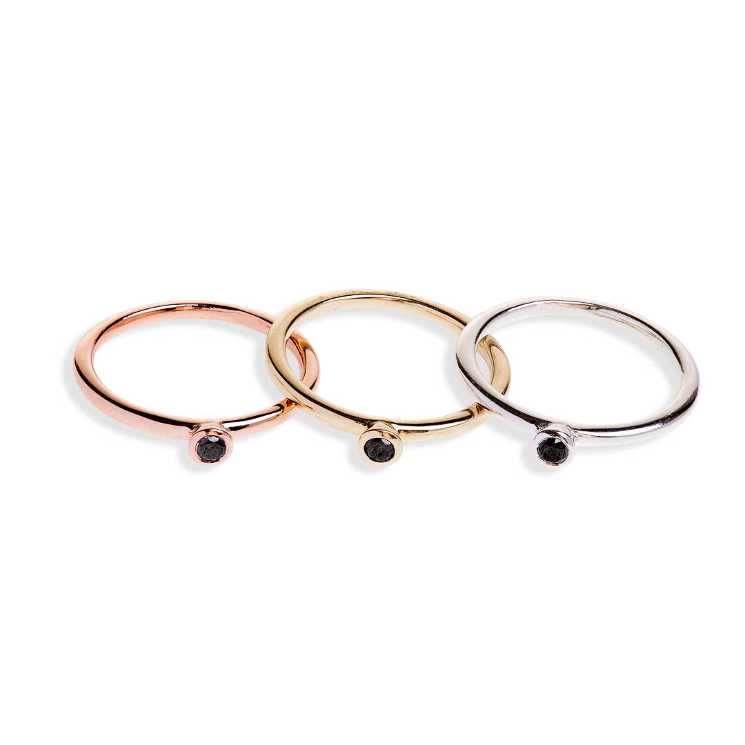 Three tube set black diamond rings in yellow gold, rose gold, and sterling silver
