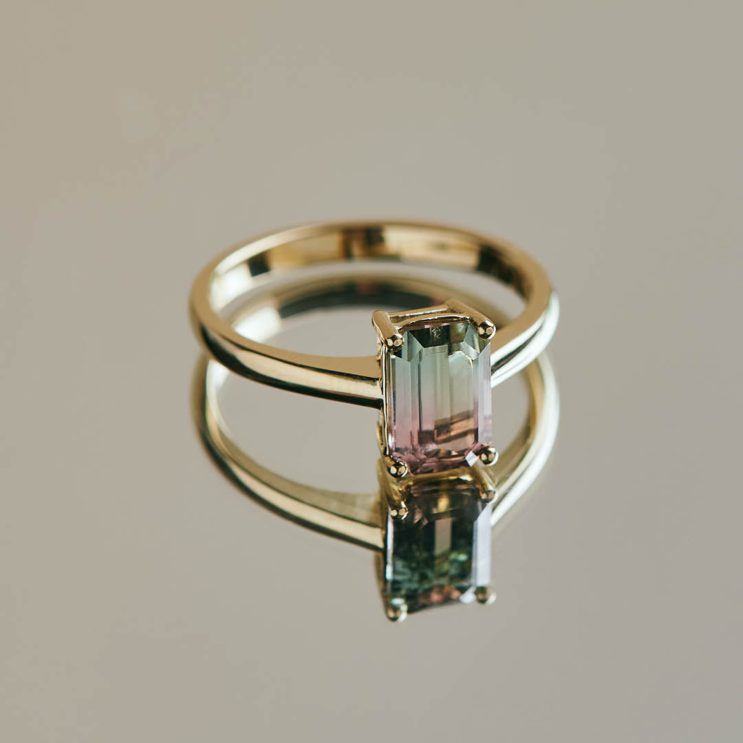 A beautifully unique light bi-colour (Watermelon) tourmaline. This special stone has both green and pink blending together and set in a classic four claw yellow gold ring
