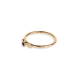 Black diamond in a classic tube setting on a yellow gold ring with two leaf details